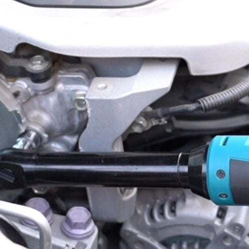 Close-up of a hand operating a Seesii cordless ratchet wrench during car engine repair.