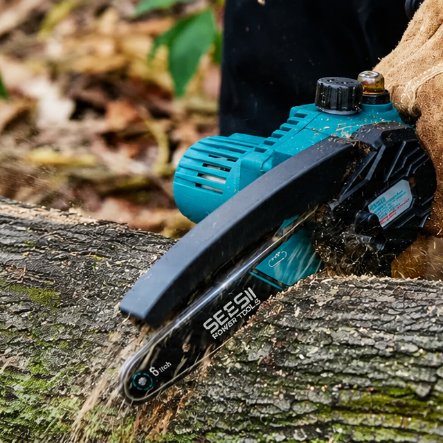 Cordless mini chainsaw cutting a fallen log